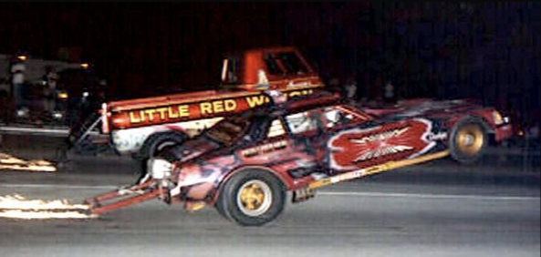 Magnum Illusion and Little Red Wagon performing side-by-side wheelstands at night